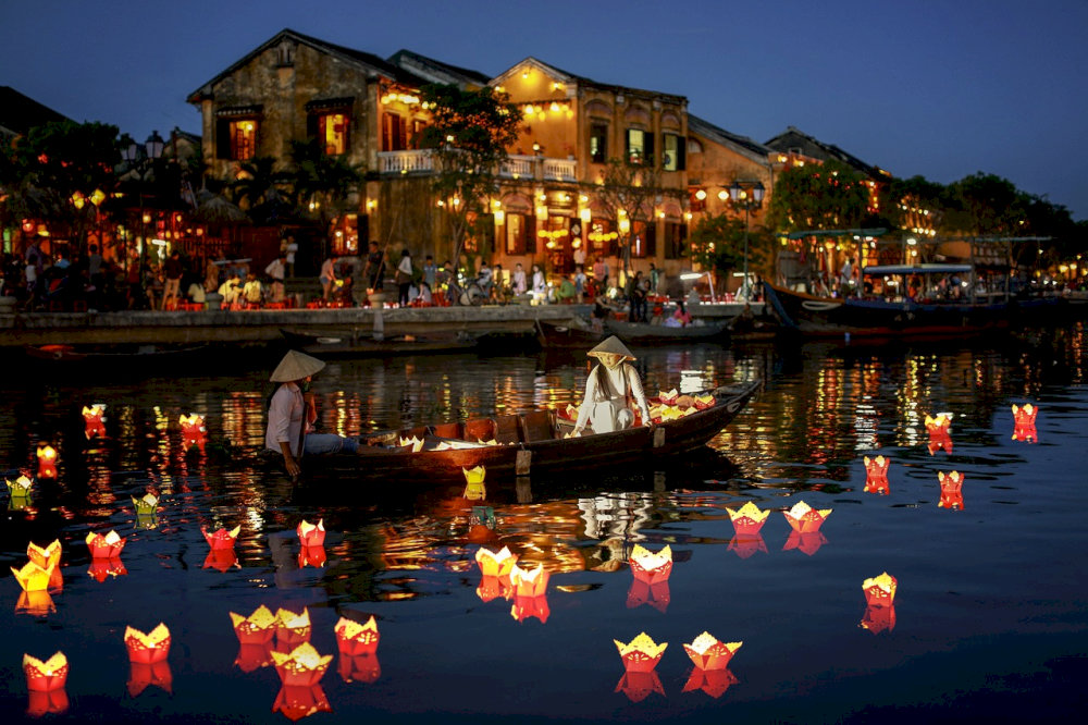 Floating lanterns illuminate the Hoai River in Hoi An